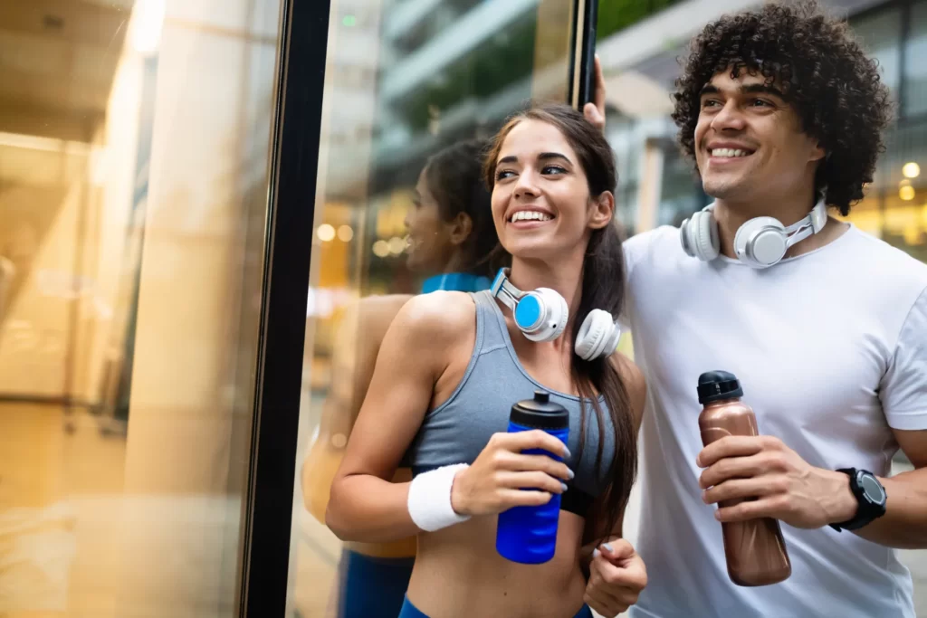 fit young adults refreshing after workout in city utc